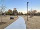Tranquil walking path through the Park Circle community featuring benches and picnic tables for residents at 1450 E Montague Ave, North Charleston, SC 29405