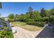 Landscaped backyard with brick patio, green grass, manicured bushes, and exterior heater at 1526 Old Rivers Gate Rd, Mount Pleasant, SC 29466