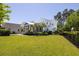 Well-maintained backyard features an attached screened in porch on a sunny day at 1526 Old Rivers Gate Rd, Mount Pleasant, SC 29466