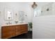 Bright bathroom featuring a double vanity, shiplap walls and herringbone tile floors at 1526 Old Rivers Gate Rd, Mount Pleasant, SC 29466