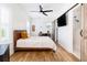 Bedroom featuring hardwood floors, barn door to bathroom, and desk at 1526 Old Rivers Gate Rd, Mount Pleasant, SC 29466