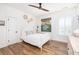 Cozy bedroom featuring hardwood floors, white trim, modern art, and a ceiling fan at 1526 Old Rivers Gate Rd, Mount Pleasant, SC 29466