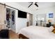 Bright bedroom featuring wood floors, sliding closet doors, and a view to the upstairs hallway at 1526 Old Rivers Gate Rd, Mount Pleasant, SC 29466