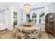 Light and airy dining room featuring a round wooden table, stylish chandelier, and lots of natural light at 1526 Old Rivers Gate Rd, Mount Pleasant, SC 29466