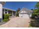 Home with a two-car garage, basketball hoop, a screened-in porch, and a well-manicured lawn at 1526 Old Rivers Gate Rd, Mount Pleasant, SC 29466
