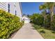 Long, private driveway leading to a detached garage, surrounded by lush greenery and well-maintained landscaping at 1526 Old Rivers Gate Rd, Mount Pleasant, SC 29466