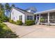 Exterior side view of a home featuring a screened-in porch, patio, and well-maintained landscaping at 1526 Old Rivers Gate Rd, Mount Pleasant, SC 29466