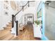 Bright foyer featuring hardwood floors, staircase, and decor, offering a welcoming first impression at 1526 Old Rivers Gate Rd, Mount Pleasant, SC 29466