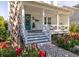Inviting front porch with brick stairs, beautiful flowerbeds, and a turquoise door, enhancing curb appeal at 1526 Old Rivers Gate Rd, Mount Pleasant, SC 29466
