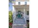 Welcoming front porch with a vibrant blue door, classic white railings, and decorative potted plants at 1526 Old Rivers Gate Rd, Mount Pleasant, SC 29466