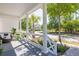Front porch featuring a seating area, white railings, flowers, and a view of the street at 1526 Old Rivers Gate Rd, Mount Pleasant, SC 29466