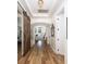 Hallway with hardwood floors, a sliding barn door and archway to a bright room at 1526 Old Rivers Gate Rd, Mount Pleasant, SC 29466