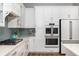 Bright kitchen with modern appliances, white cabinetry, granite countertops, and attractive backsplash at 1526 Old Rivers Gate Rd, Mount Pleasant, SC 29466