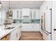 Bright kitchen featuring white cabinetry, granite countertops, stainless appliances, and a lovely blue tiled backsplash at 1526 Old Rivers Gate Rd, Mount Pleasant, SC 29466