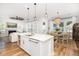 Spacious kitchen area with granite counters, a modern island, dining area, and open floor plan to living room at 1526 Old Rivers Gate Rd, Mount Pleasant, SC 29466