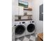 Laundry room with stacked washer and dryer and floating shelves at 1526 Old Rivers Gate Rd, Mount Pleasant, SC 29466
