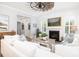 Cozy living room with fireplace, white sofas, and natural light, creating a relaxing atmosphere at 1526 Old Rivers Gate Rd, Mount Pleasant, SC 29466