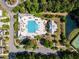 Aerial view of a community pool featuring ample seating, a playground, and a view of a peaceful pond at 1526 Old Rivers Gate Rd, Mount Pleasant, SC 29466
