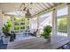 Inviting screened-in porch with comfortable seating, wood floors, and a vaulted ceiling at 1526 Old Rivers Gate Rd, Mount Pleasant, SC 29466