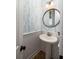 Charming powder room featuring blue leaf wallpaper, beadboard, a pedestal sink and lovely mirror at 1526 Old Rivers Gate Rd, Mount Pleasant, SC 29466