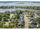 Aerial view of a neighborhood with lush greenery, marsh, and a waterfront in the distance at 1562 Charming Nancy Rd, Charleston, SC 29412