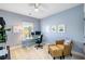 Bedroom with blue walls, desk, office chair, and a comfortable wicker chair with ottoman at 1562 Charming Nancy Rd, Charleston, SC 29412