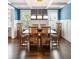 Elegant dining room with wainscoting, blue textured wallpaper, coffered ceiling, and seating for eight at 1562 Charming Nancy Rd, Charleston, SC 29412