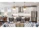 Stylish kitchen with a large island, designer pendant lights, stainless appliances, and open access to the living area at 1562 Charming Nancy Rd, Charleston, SC 29412