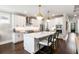 Modern kitchen with a large island, white cabinetry, stainless steel appliances, and elegant pendant lighting at 1562 Charming Nancy Rd, Charleston, SC 29412
