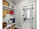 Mud room with coat rack, storage bench with pillows, and shelves with baskets and an entryway to a laundry room at 1562 Charming Nancy Rd, Charleston, SC 29412