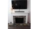Attractive fireplace featuring a decorative mantel, stone surround, and TV mounted above at 1651 Indy Dr, North Charleston, SC 29405