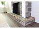 Close up of the fireplace with stone surround, raised hearth, and plank wall at 1651 Indy Dr, North Charleston, SC 29405