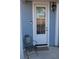 Attractive white door with glass panes and green metal chair at 1651 Indy Dr, North Charleston, SC 29405