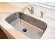 Close-up of stainless steel kitchen sink with modern faucet and white countertop, complemented by a subway tile backsplash at 1651 Indy Dr, North Charleston, SC 29405