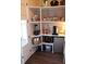 Well-organized pantry with open shelves, a mini fridge and laminate flooring, providing ample storage space at 1651 Indy Dr, North Charleston, SC 29405