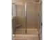 Tiled shower with glass door, features a built-in corner seat, providing a modern and convenient bathing experience at 1651 Indy Dr, North Charleston, SC 29405
