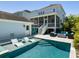Inviting backyard pool with lounge chairs in pool and an outdoor seating area with a fire pit at 1659 Pierce St, Daniel Island, SC 29492