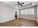 Bright bedroom featuring trey ceiling, ceiling fan, wood flooring and plantation shutters on the windows at 1659 Pierce St, Daniel Island, SC 29492