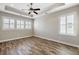 Bright bedroom featuring trey ceiling, ceiling fan, wood flooring and plantation shutters on the windows at 1659 Pierce St, Daniel Island, SC 29492