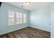 Bright bedroom featuring wood flooring and plantation shutters on the windows at 1659 Pierce St, Daniel Island, SC 29492
