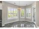 Bright dining nook with chandelier, plantation shutters, and wood-look tile flooring at 1659 Pierce St, Daniel Island, SC 29492