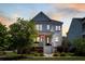 Classic two-story home with a welcoming porch, illuminated by the warm glow of twilight at 1659 Pierce St, Daniel Island, SC 29492