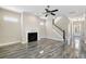 Spacious living room with fireplace, wood-look tile floors, and staircase with wood railing at 1659 Pierce St, Daniel Island, SC 29492
