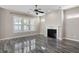 Bright living room featuring fireplace, wood-look tile floors, and plantation shutters at 1659 Pierce St, Daniel Island, SC 29492