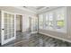 Bright office space with wood-look tile floors, white trim, and plantation shutters allowing natural light at 1659 Pierce St, Daniel Island, SC 29492