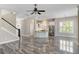 Open concept living space with wood-look tile floors, staircase, kitchen, and dining area at 1659 Pierce St, Daniel Island, SC 29492