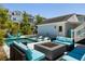 Resort style backyard with a large pool, in-pool loungers, an outdoor fire pit, ample seating, and a covered porch at 1659 Pierce St, Daniel Island, SC 29492