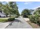 Street view of the neighborhood lined with trees and sidewalks at 1659 Pierce St, Daniel Island, SC 29492
