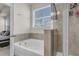 Bathroom featuring a soaking tub, glass enclosed shower and window providing natural light at 171 Sara St, Saint George, SC 29477