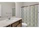 Bathroom highlighting a single vanity with a quartz countertop and a shower featuring a patterned shower curtain at 171 Sara St, Saint George, SC 29477
